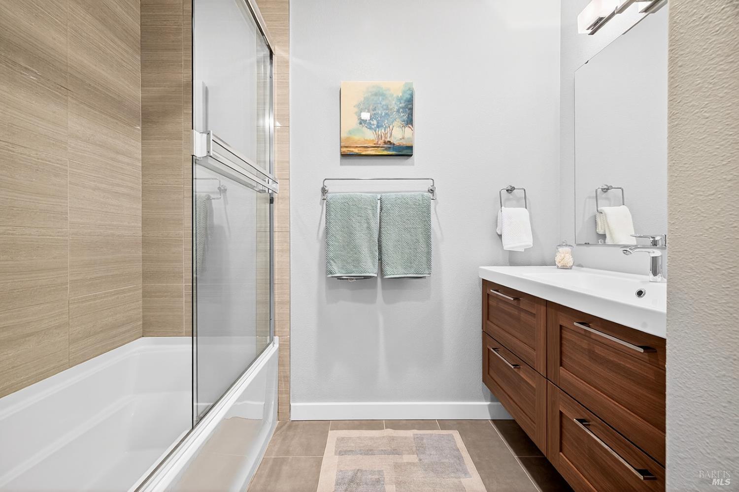 4720 Granada Drive Santa Rosa, CA 95409 - Photo 47 of 68 a bathroom with a double vanity sink a mirror and a bathtub