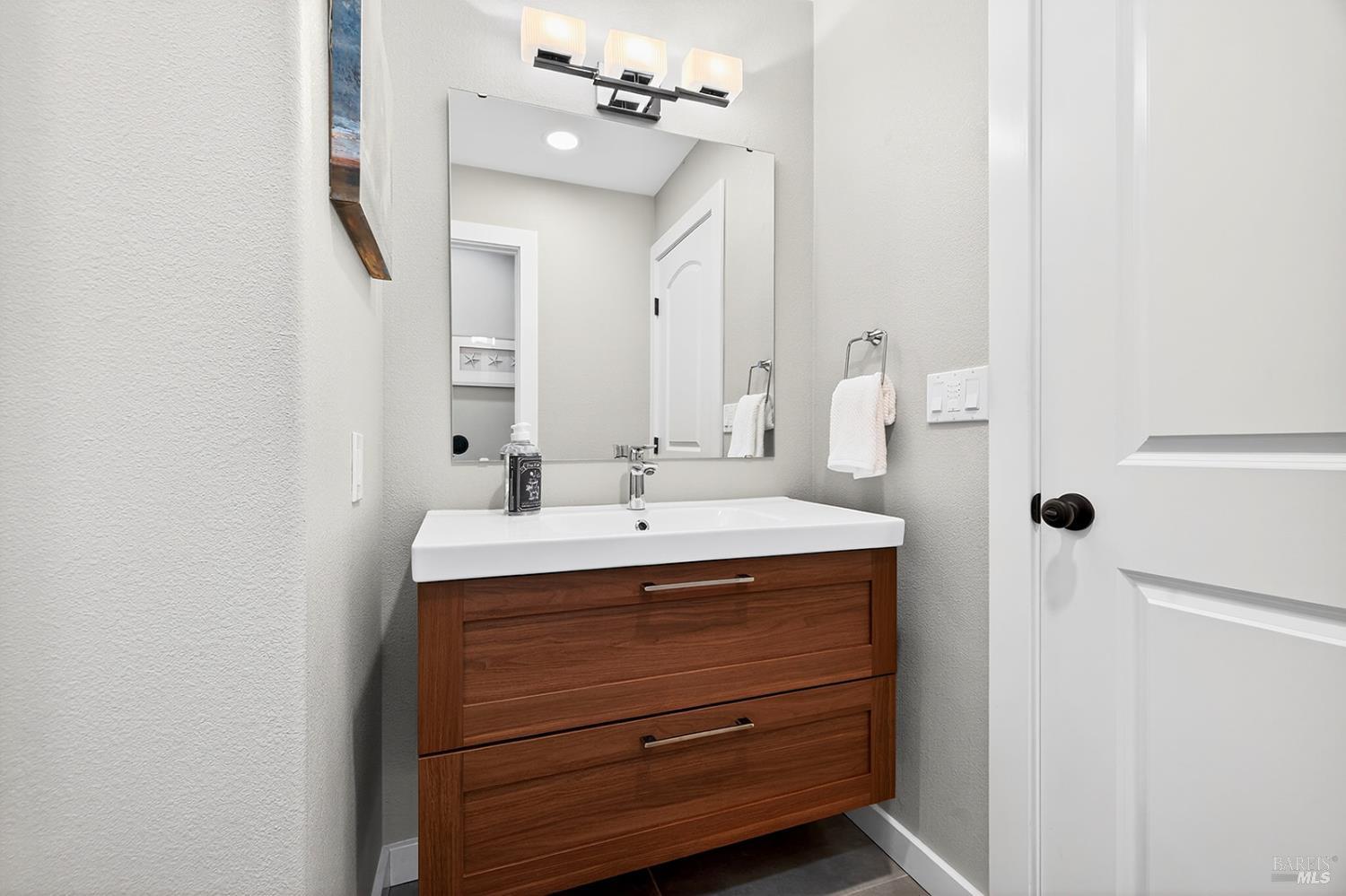 4720 Granada Drive Santa Rosa, CA 95409 - Photo 50 of 68 a bathroom with a sink vanity and mirror