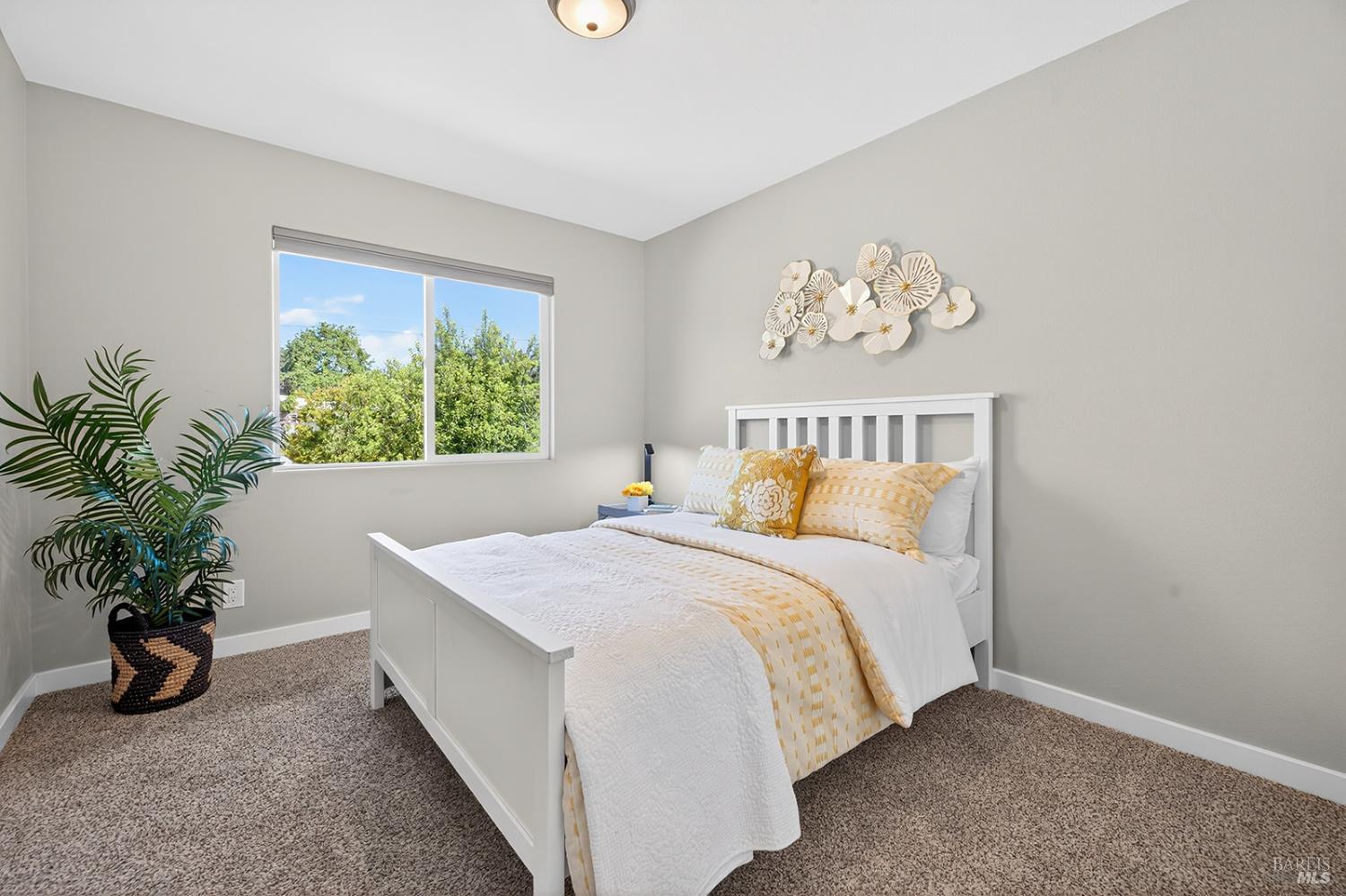 4720 Granada Drive Santa Rosa, CA 95409 - Photo 51 of 68 a bedroom with a bed and a potted plant