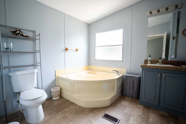 a spacious bathroom with a bathtub and toilet