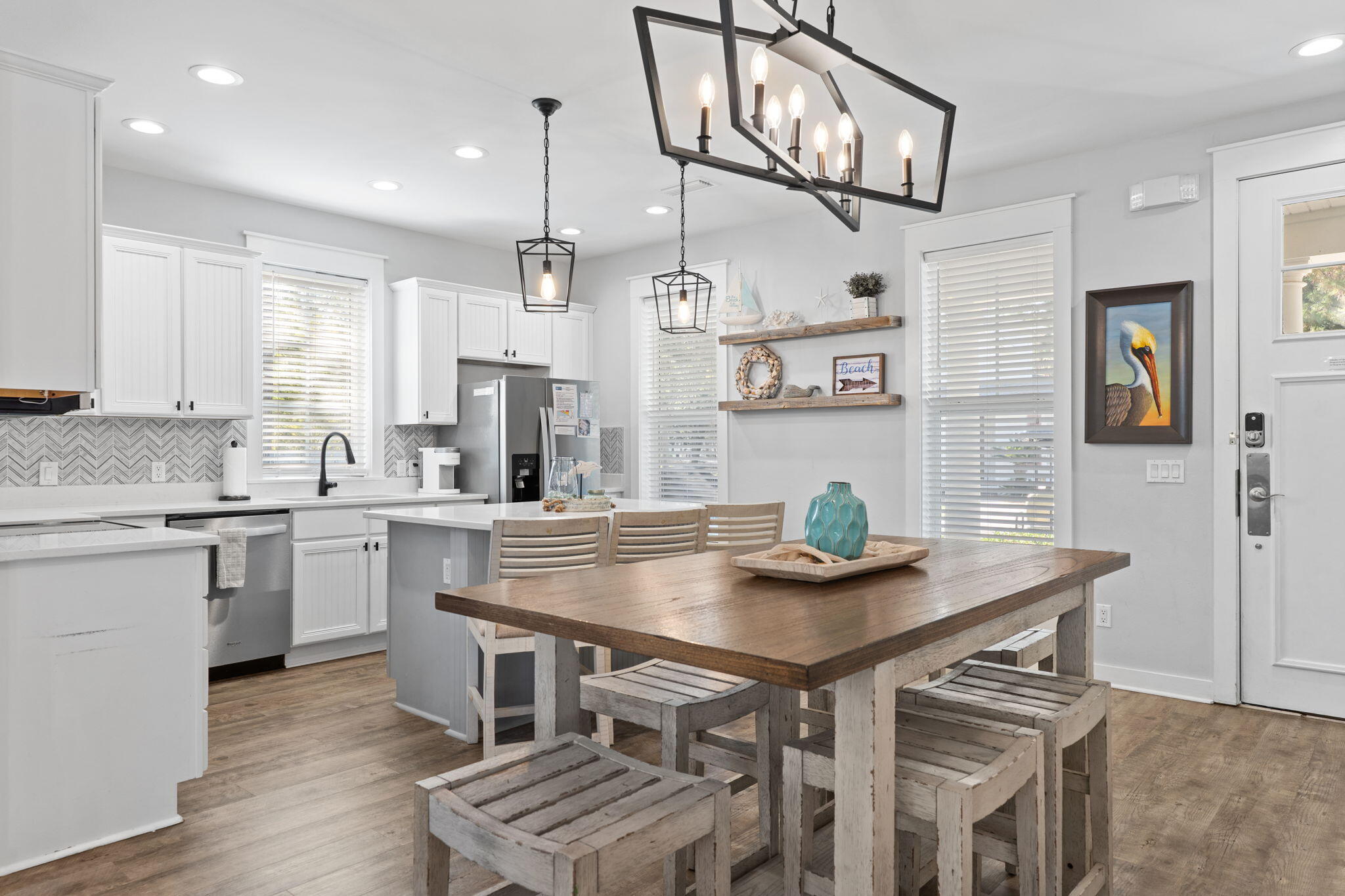 1352 Ravens Run West Miramar Beach, FL 32550 - Photo 13 of 50 a kitchen with stainless steel appliances a table chairs and a refrigerator