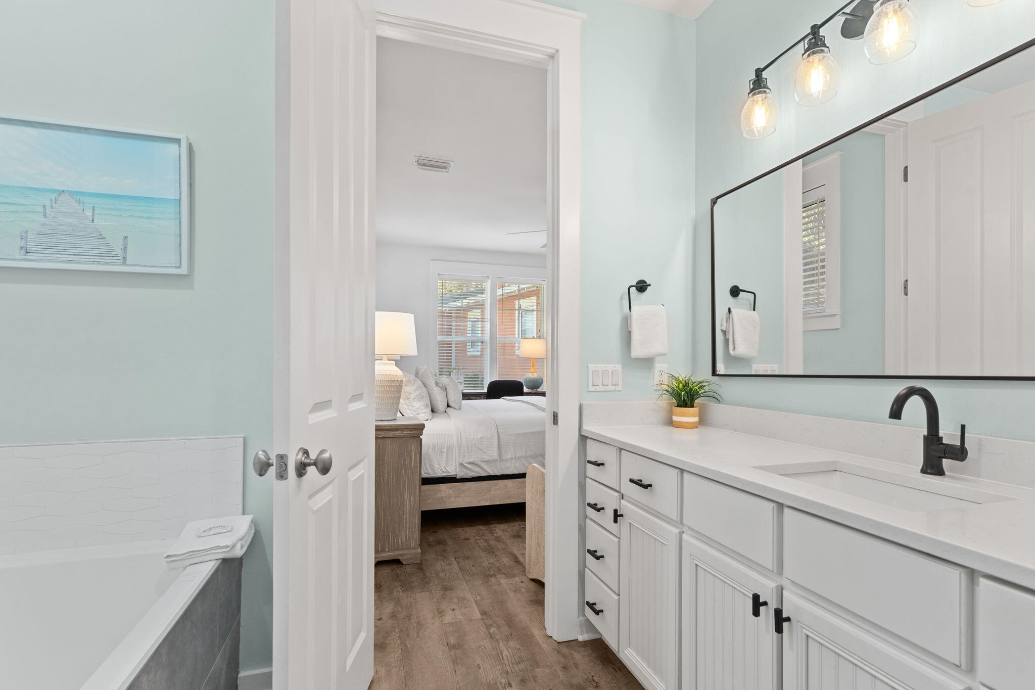 1352 Ravens Run West Miramar Beach, FL 32550 - Photo 27 of 50 a en suite bathroom with a double vanity sink a mirror and a bathtub