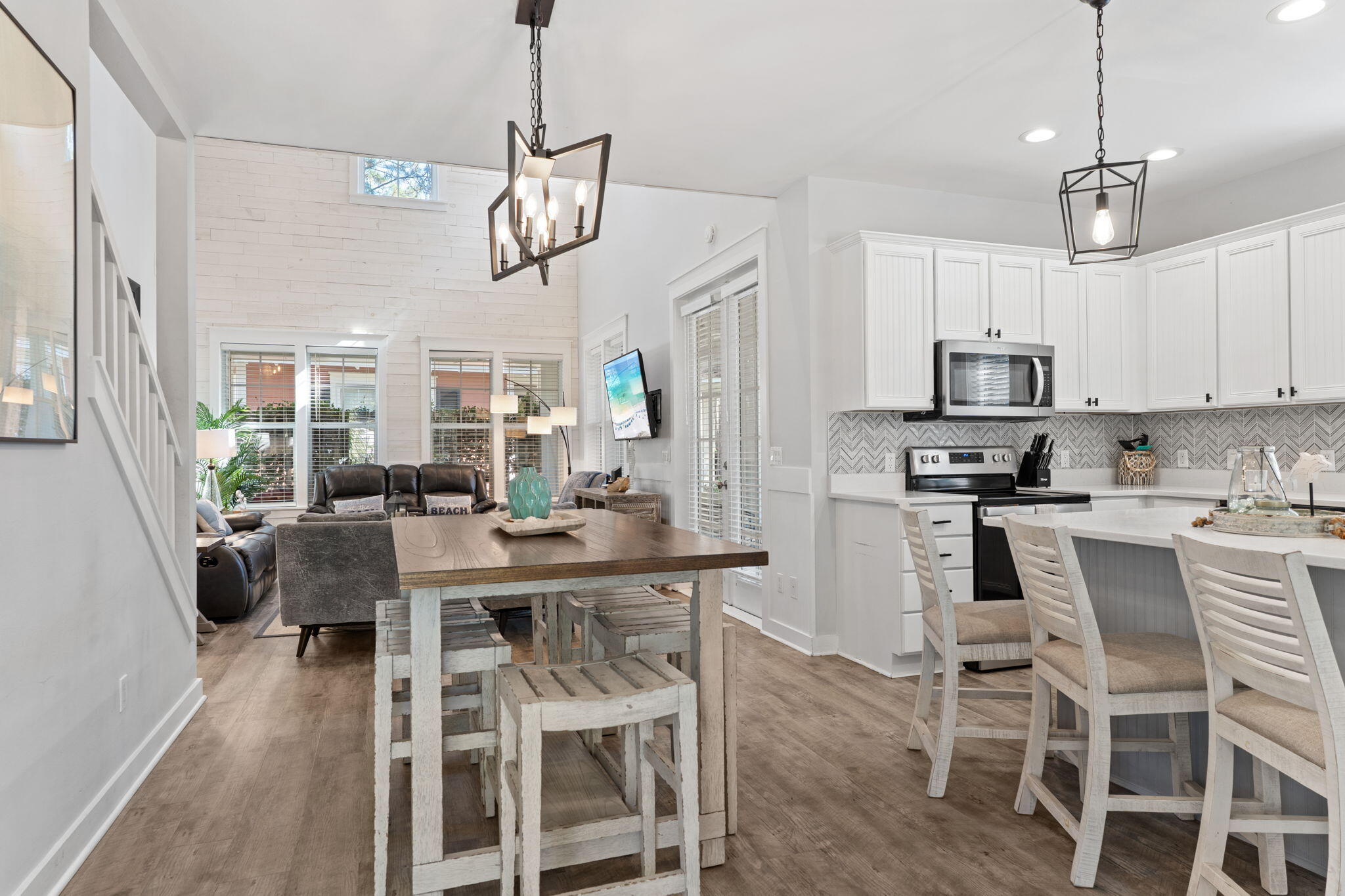 1352 Ravens Run West Miramar Beach, FL 32550 - Photo 4 of 50 a view of a dining room with furniture a chandelier and wooden floor