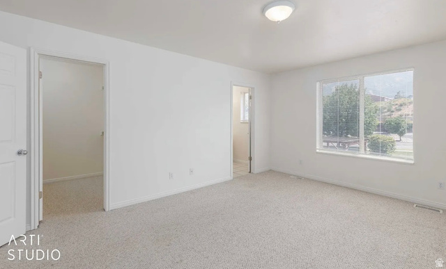 4823 Old Post Road Ogden, UT 84403 - Photo 17 of 19 Neutral-toned carpeting, white walls, and a flush-mount ceiling light
