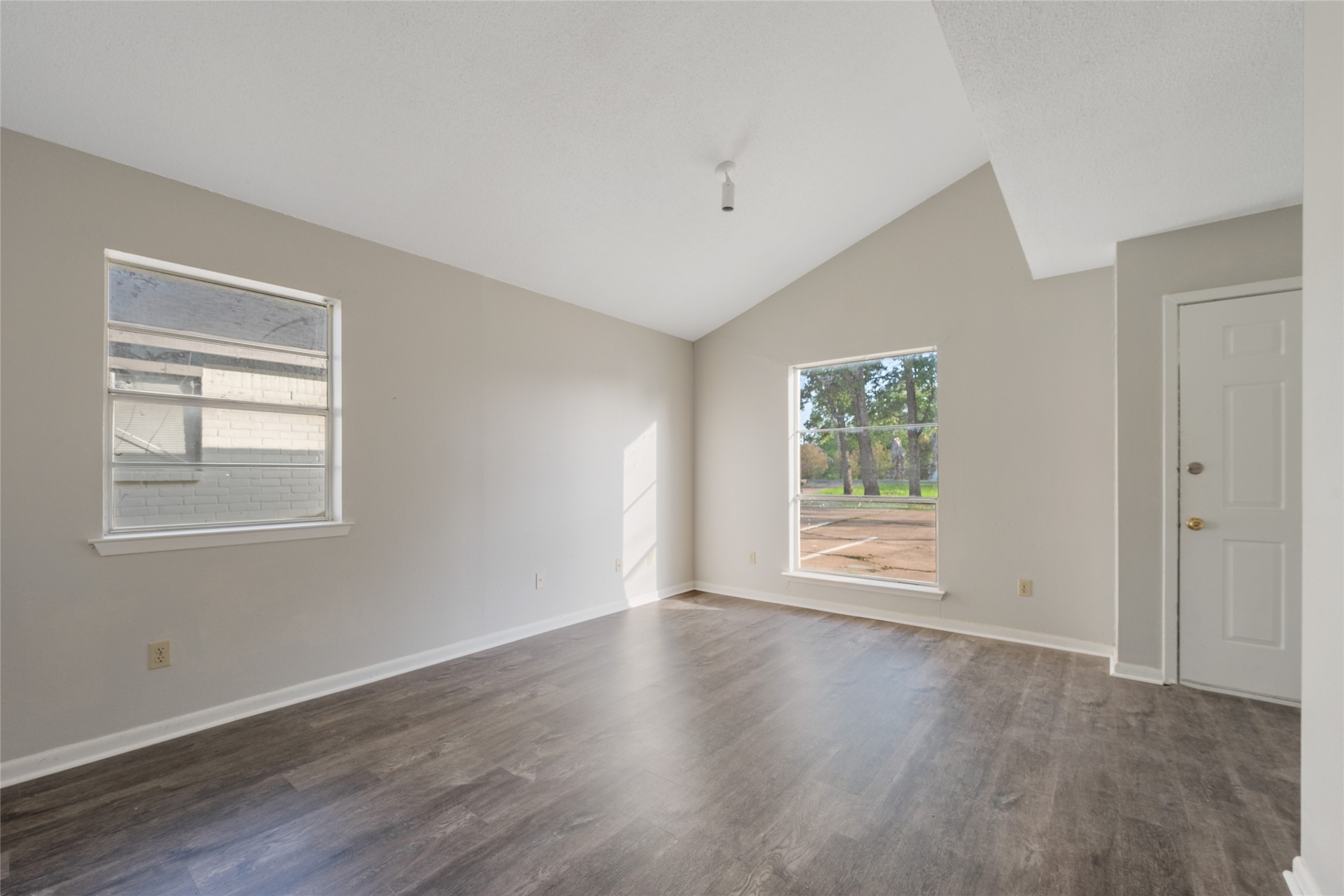 4123 Old Hearne Road Bryan, TX 77803 - Photo 3 of 11 a view of an empty room with wooden floor and a window