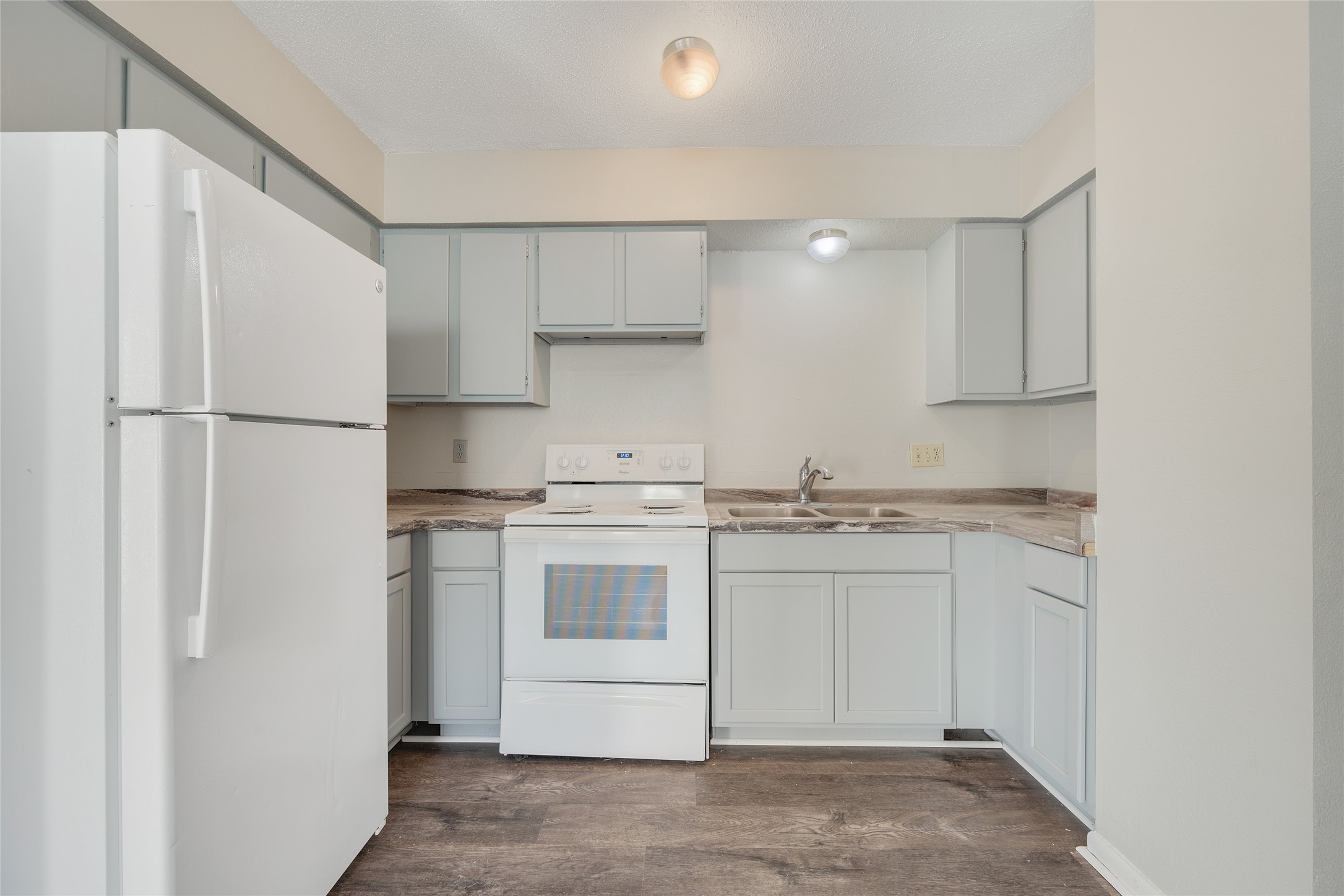 4123 Old Hearne Road Bryan, TX 77803 - Photo 6 of 11 a kitchen with stainless steel appliances granite countertop a refrigerator sink and white cabinets