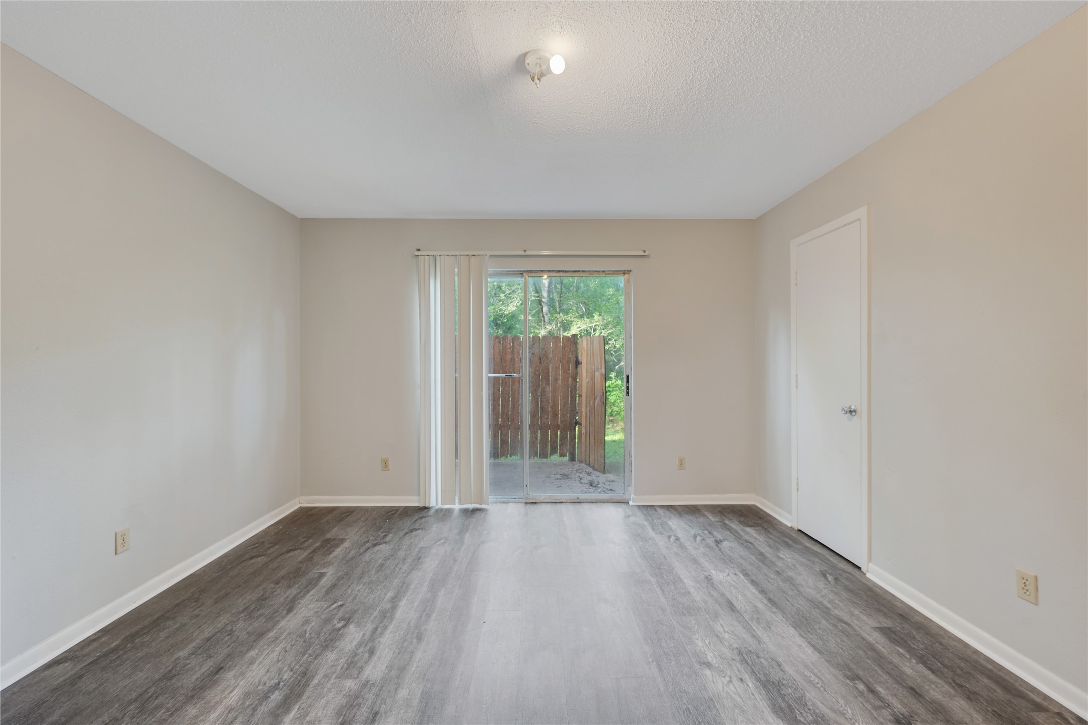 4123 Old Hearne Road Bryan, TX 77803 - Photo 7 of 11 an empty room with wooden floor and windows