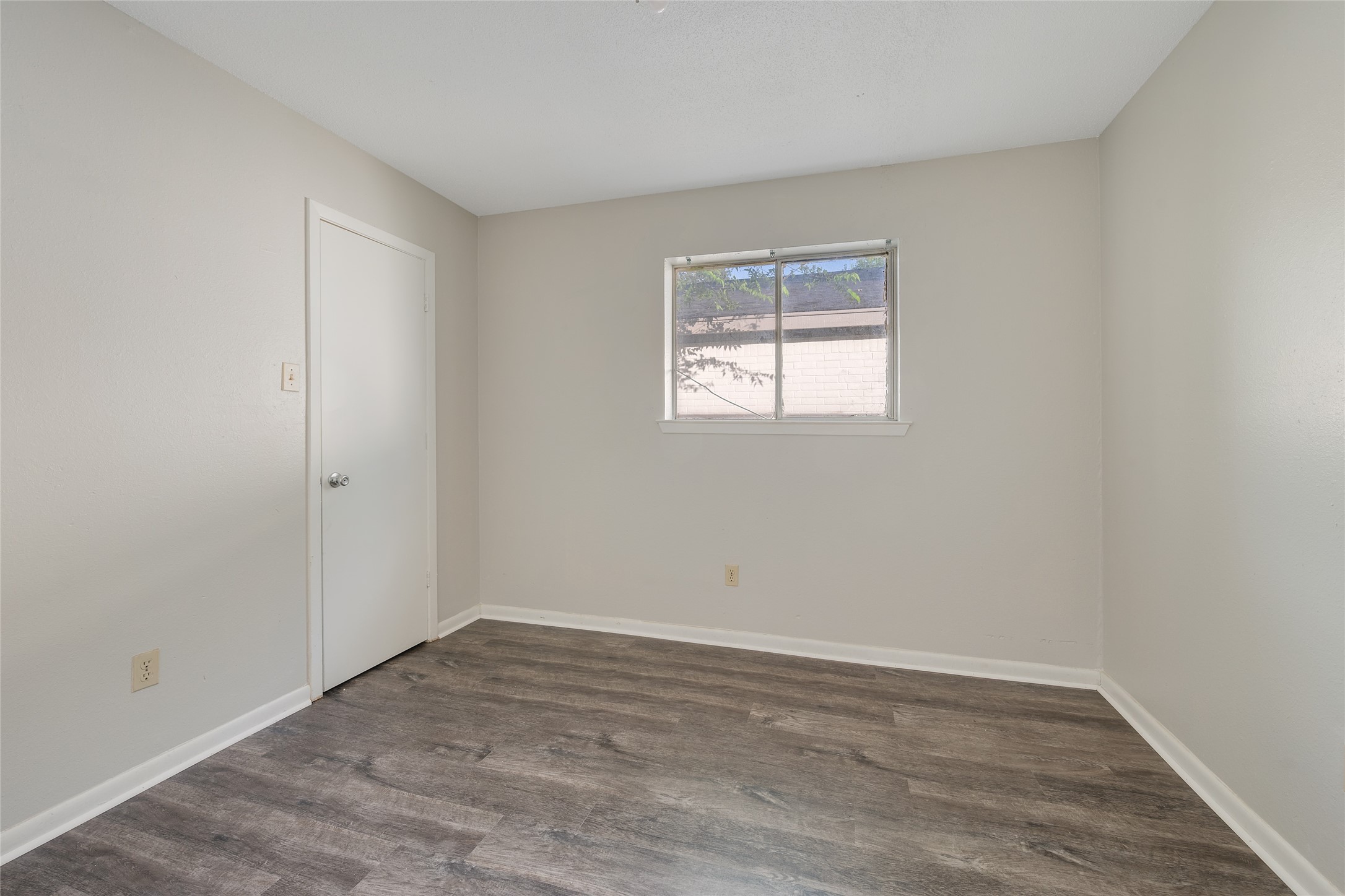 4123 Old Hearne Road Bryan, TX 77803 - Photo 9 of 11 a view of an empty room with wooden floor and a window