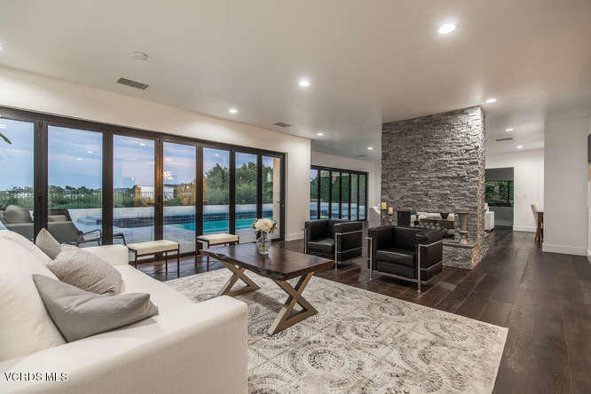 3812 Westfall Drive Encino, CA 91436 - Photo 4 of 52 a living room with furniture large windows and wooden floor