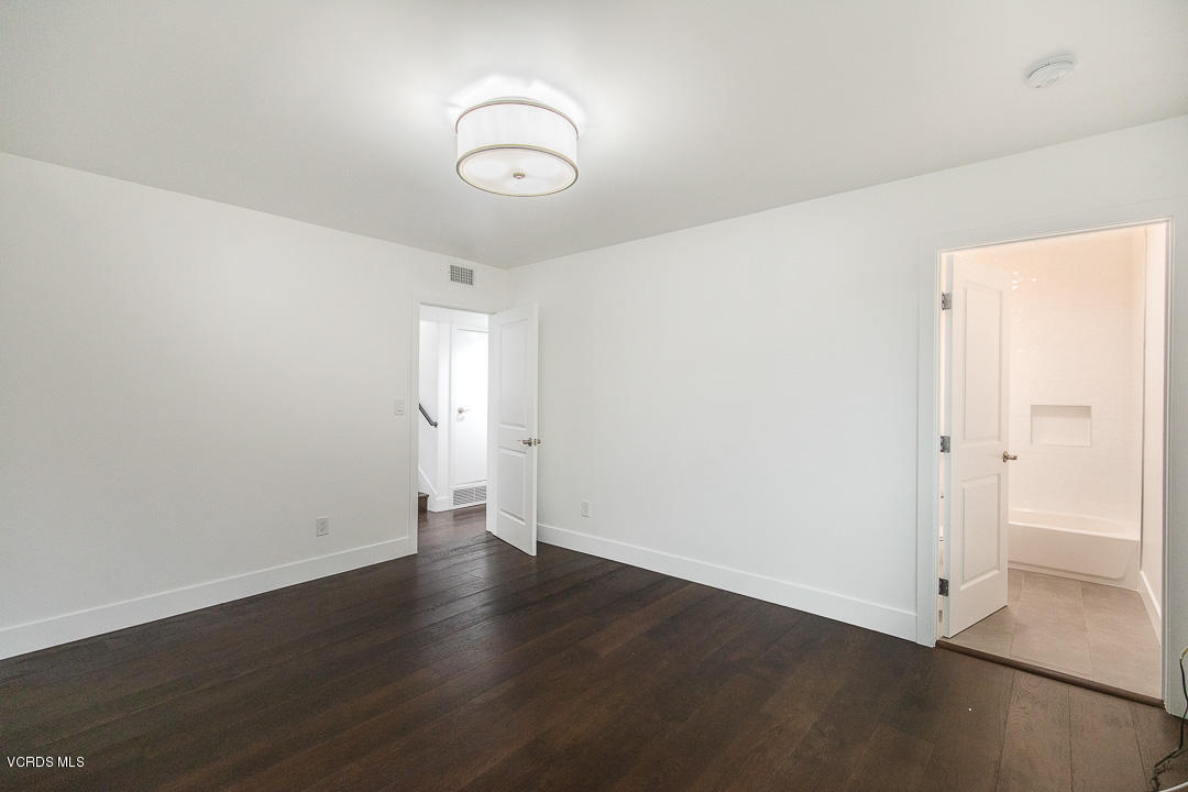 3812 Westfall Drive Encino, CA 91436 - Photo 33 of 52 an empty room with wooden floor and window