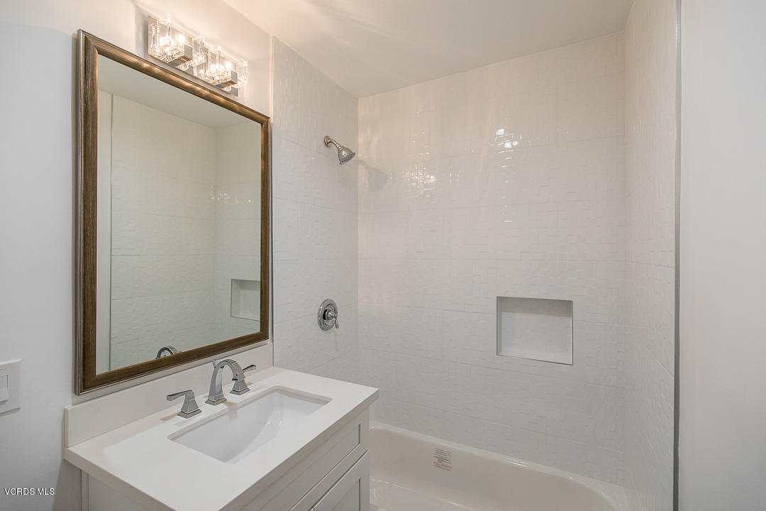 3812 Westfall Drive Encino, CA 91436 - Photo 34 of 52 a bathroom with a sink a mirror and a bathtub