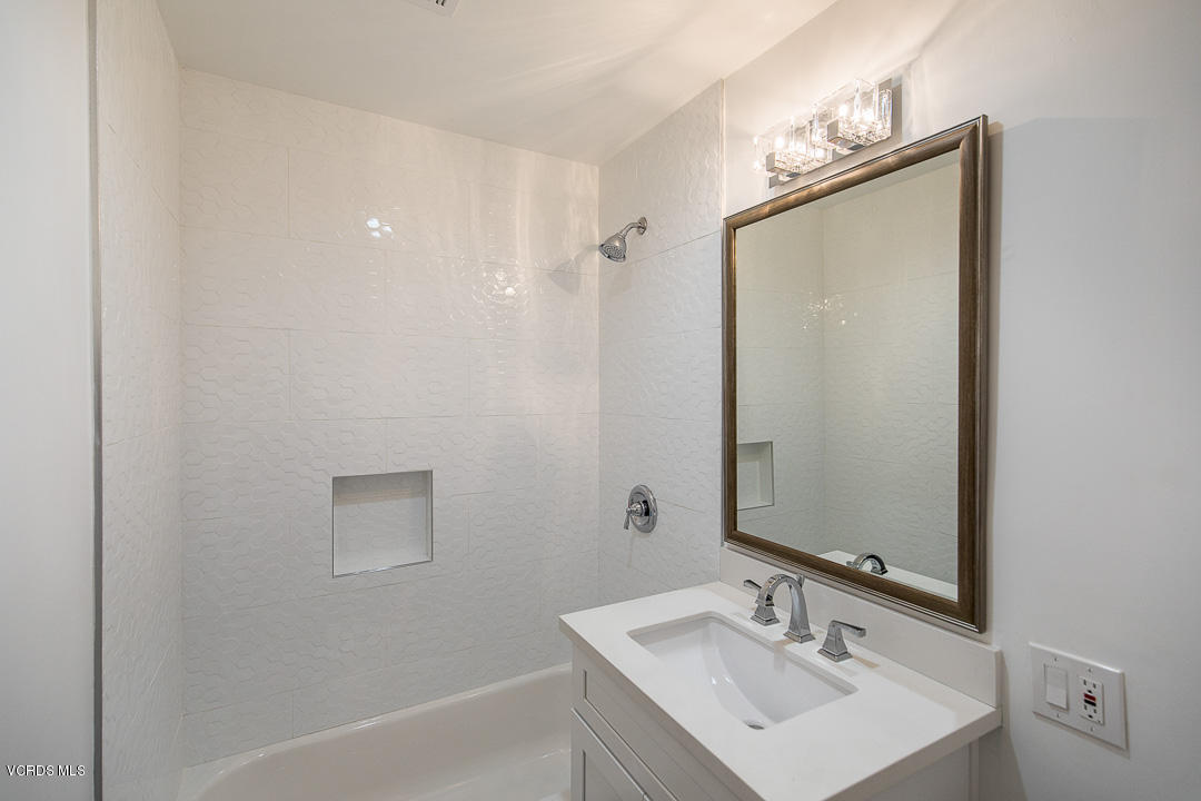 3812 Westfall Drive Encino, CA 91436 - Photo 36 of 52 a bathroom with a sink mirror and a bathtub