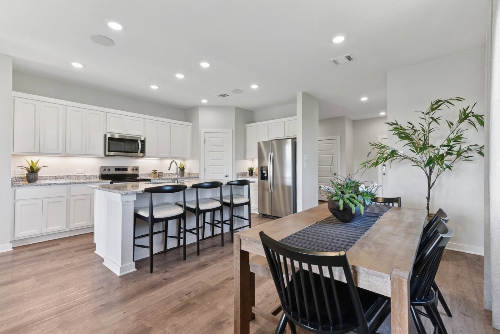112 Hornet Street Elgin, TX 78621 - Photo 5 of 25 a kitchen with granite countertop white cabinets and stainless steel appliances