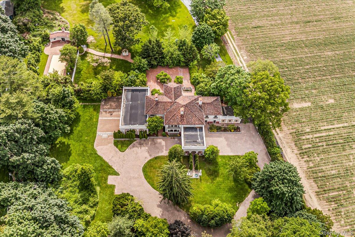 952 Cedar Swamp Road Glen Head, NY 11545 - Photo 2 of 50 an aerial view of a house with a yard and large trees