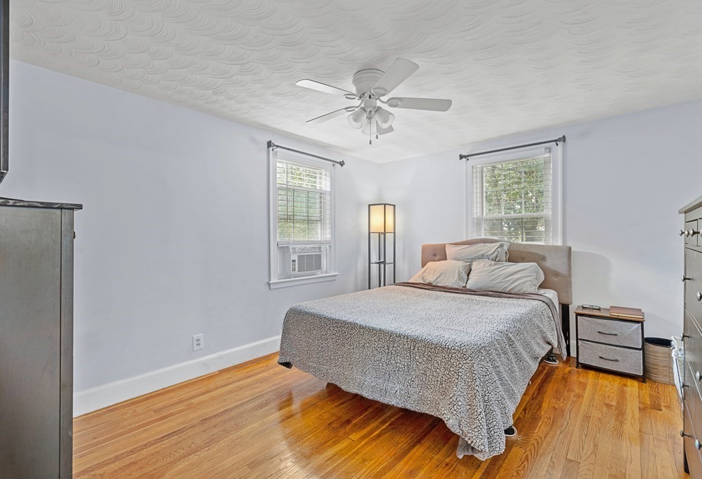 43 Fairview Street Dedham, MA 02026 - Photo 11 of 29 a bedroom with a bed and wooden floor
