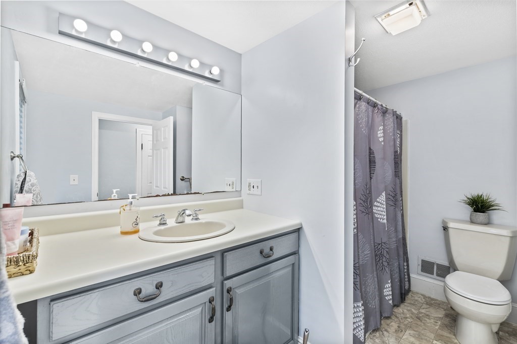 43 Fairview Street Dedham, MA 02026 - Photo 13 of 29 a bathroom with a sink a toilet a mirror and shower