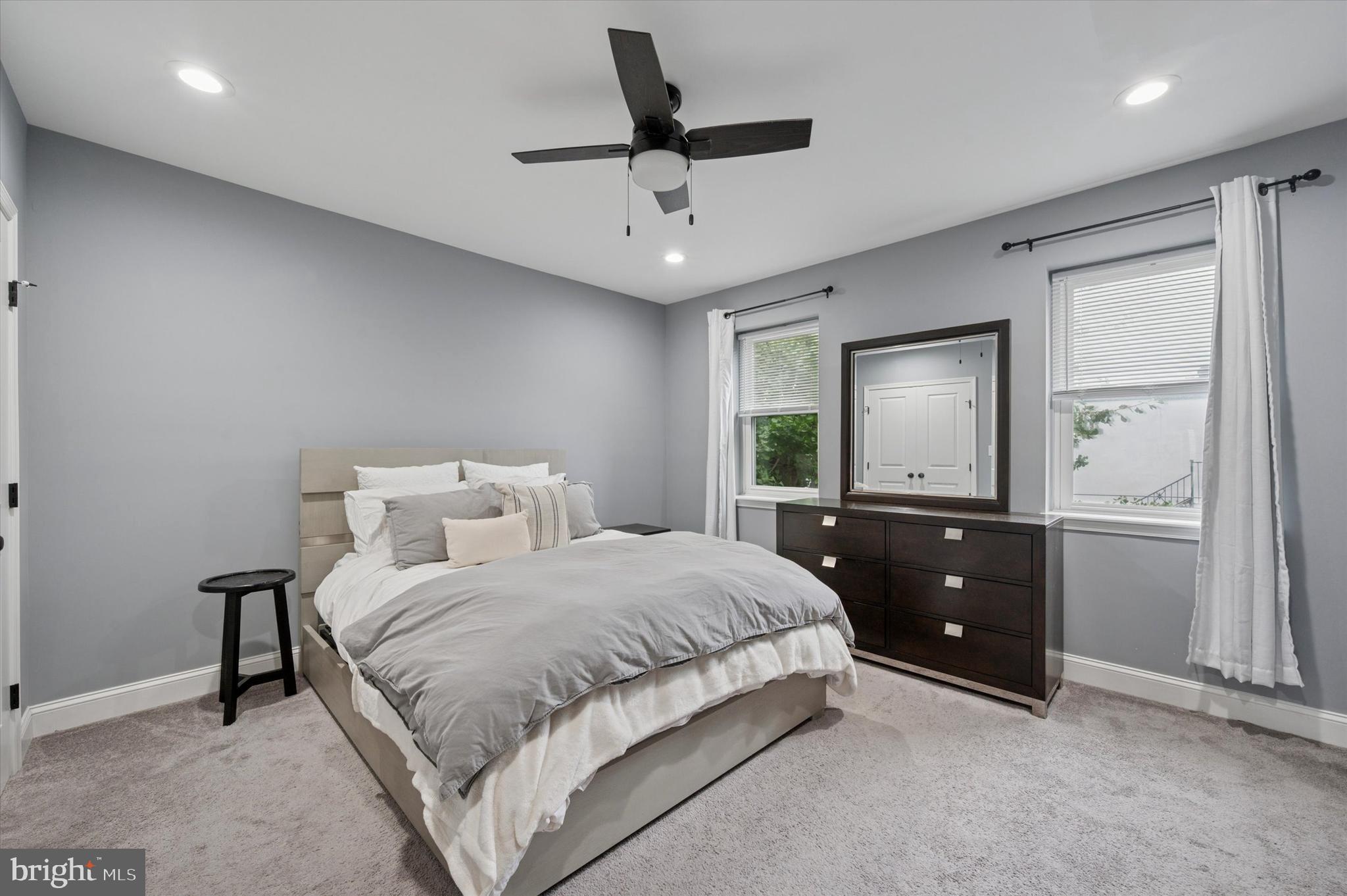 2458 Cedar Street Philadelphia, PA 19125 - Photo 14 of 15 a bedroom with a bed and a chandelier