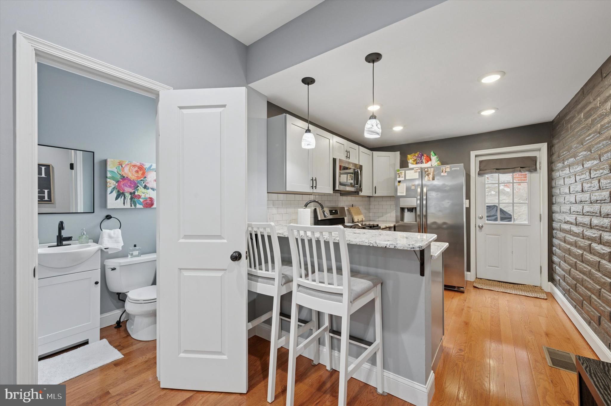 2458 Cedar Street Philadelphia, PA 19125 - Photo 7 of 15 a kitchen that has a lot of cabinets a sink and wooden floor