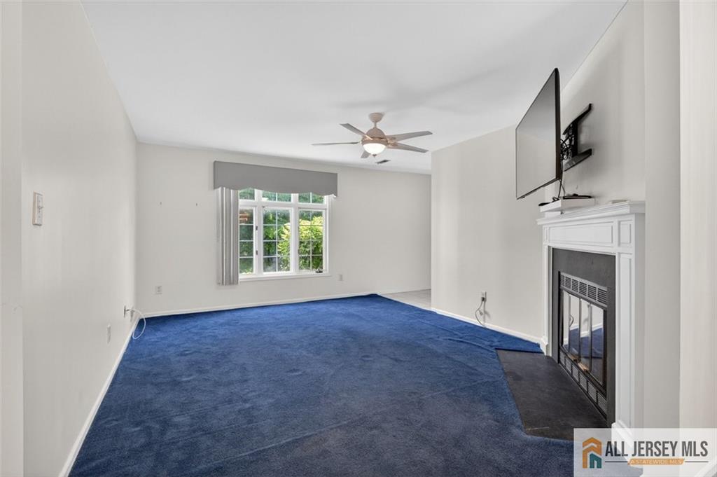 40C Rutland Lane, Unit 40B Monroe Township, NJ 08831 - Photo 3 of 37 a view of empty room with fireplace and fan