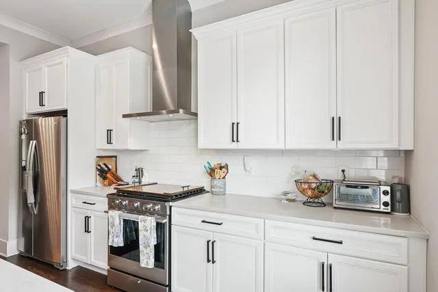 a kitchen with stainless steel appliances granite countertop a sink a stove and a refrigerator