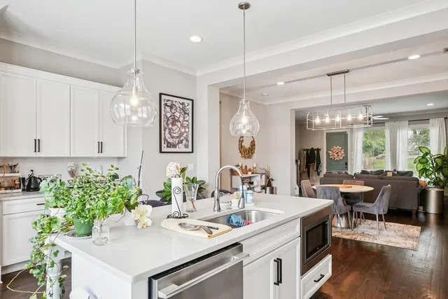 a kitchen with a table chairs stove and cabinets