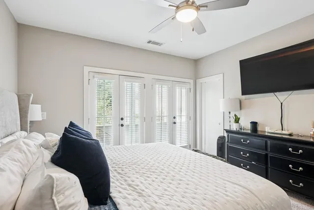 a bedroom with a bed and a flat screen tv