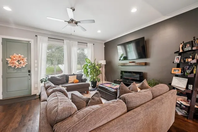 a living room with furniture a fireplace and a flat screen tv