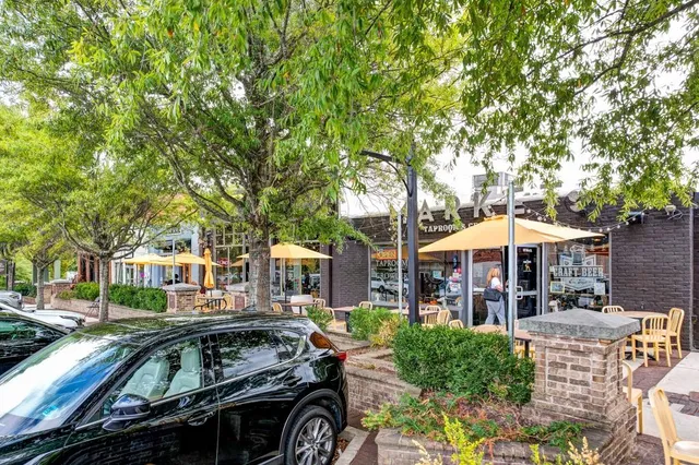 a view of a patio with couches and table and chairs under an umbrella