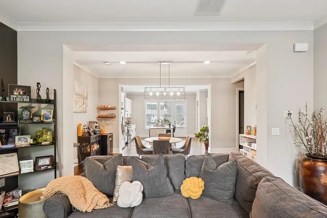 a living room with furniture and a chandelier