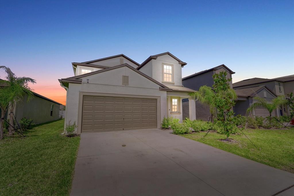 111 Rain Lily Ave Spring Hill Spring Hill, FL 34609 - Photo 11 of 60 a front view of a house with a yard and garage