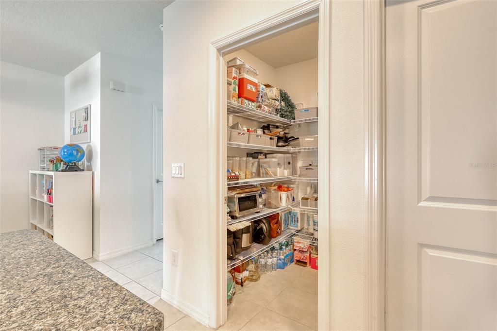111 Rain Lily Ave Spring Hill Spring Hill, FL 34609 - Photo 13 of 60 a view of a livingroom with shelves