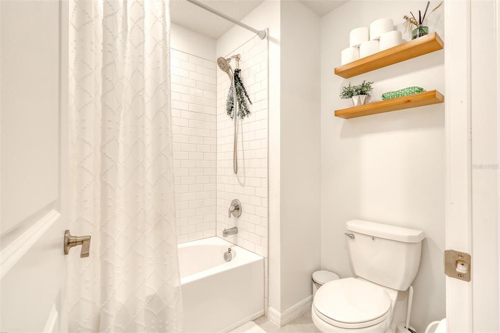 111 Rain Lily Ave Spring Hill Spring Hill, FL 34609 - Photo 16 of 60 a white toilet sitting next to a bath tub