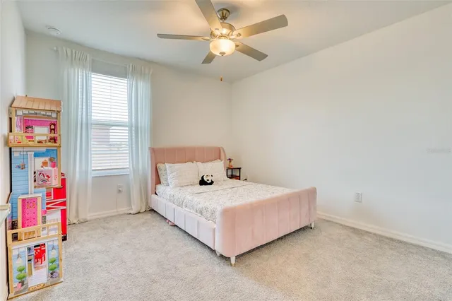 a bedroom with a bed and a ceiling fan