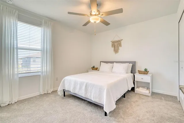 a front view of a house with a yard and potted plants