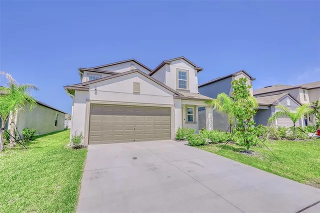 a view of a backyard with sitting area