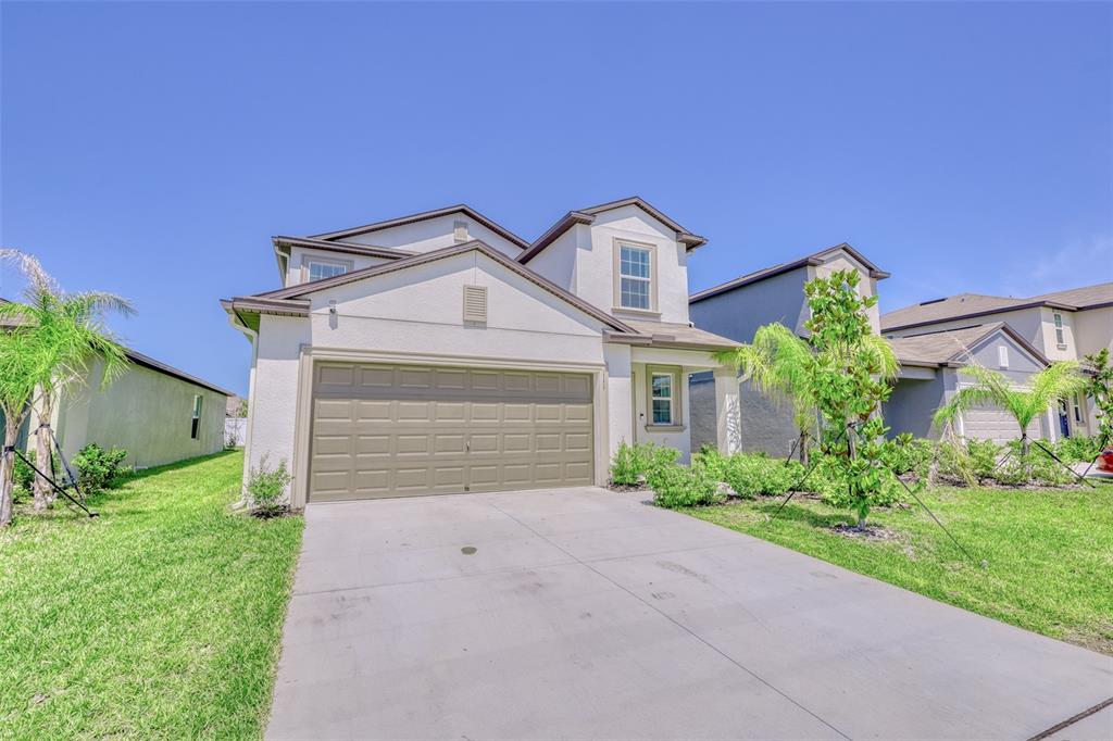 111 Rain Lily Ave Spring Hill Spring Hill, FL 34609 - Photo 22 of 60 front view of a house with a yard