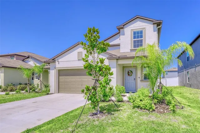 a view of a backyard with table and chairs