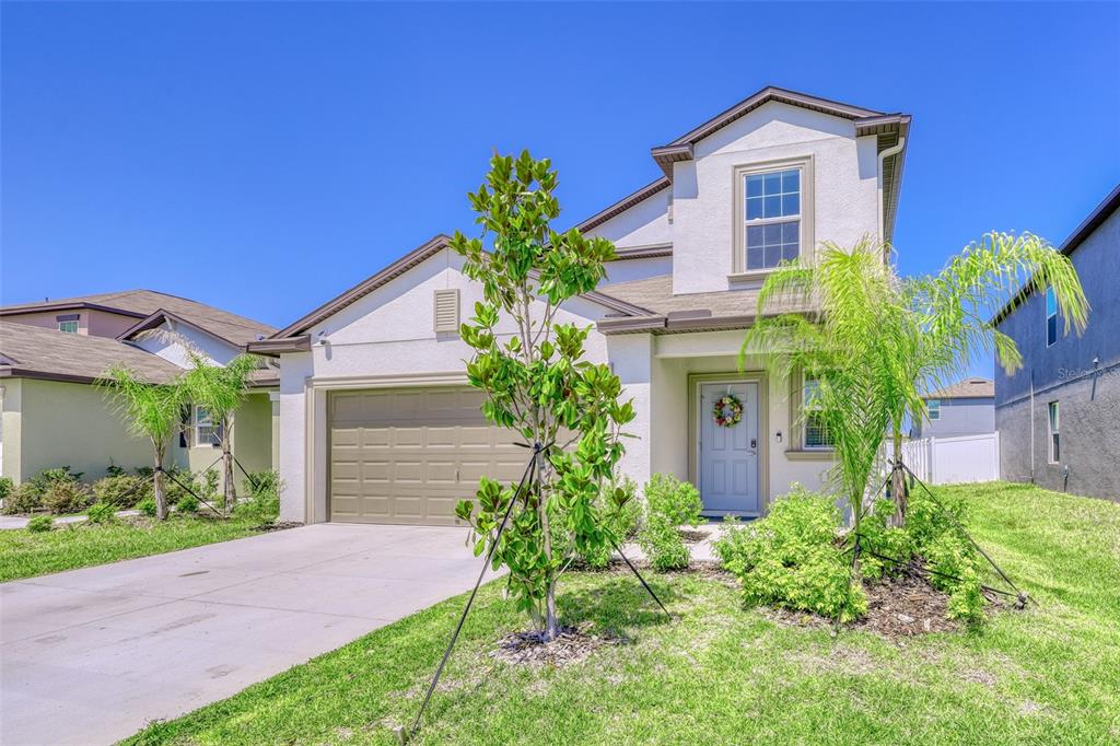 111 Rain Lily Ave Spring Hill Spring Hill, FL 34609 - Photo 24 of 60 a front view of a house with a yard
