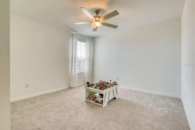 a white toilet sitting next to a white wall
