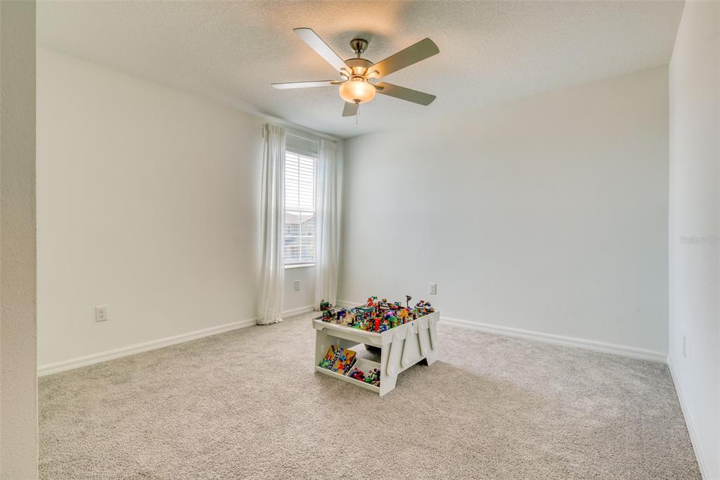 111 Rain Lily Ave Spring Hill Spring Hill, FL 34609 - Photo 31 of 60 an empty room with windows and ceiling fan