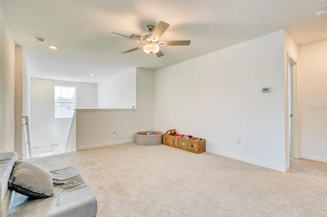 a living room with a table and a potted plant