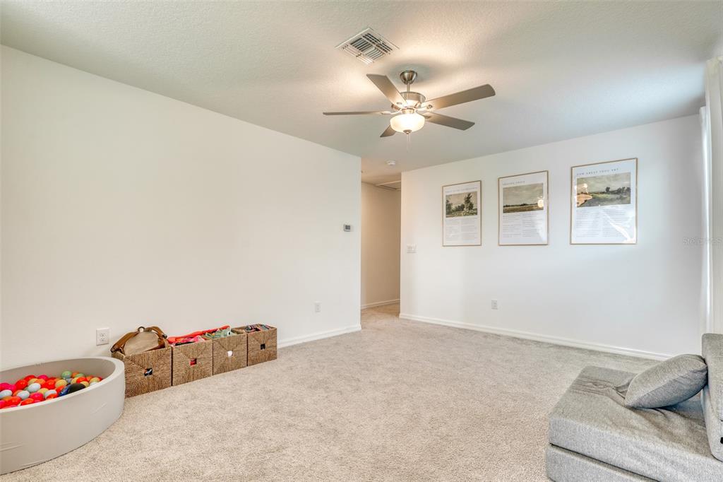 111 Rain Lily Ave Spring Hill Spring Hill, FL 34609 - Photo 33 of 60 a view of a livingroom with a ceiling fan