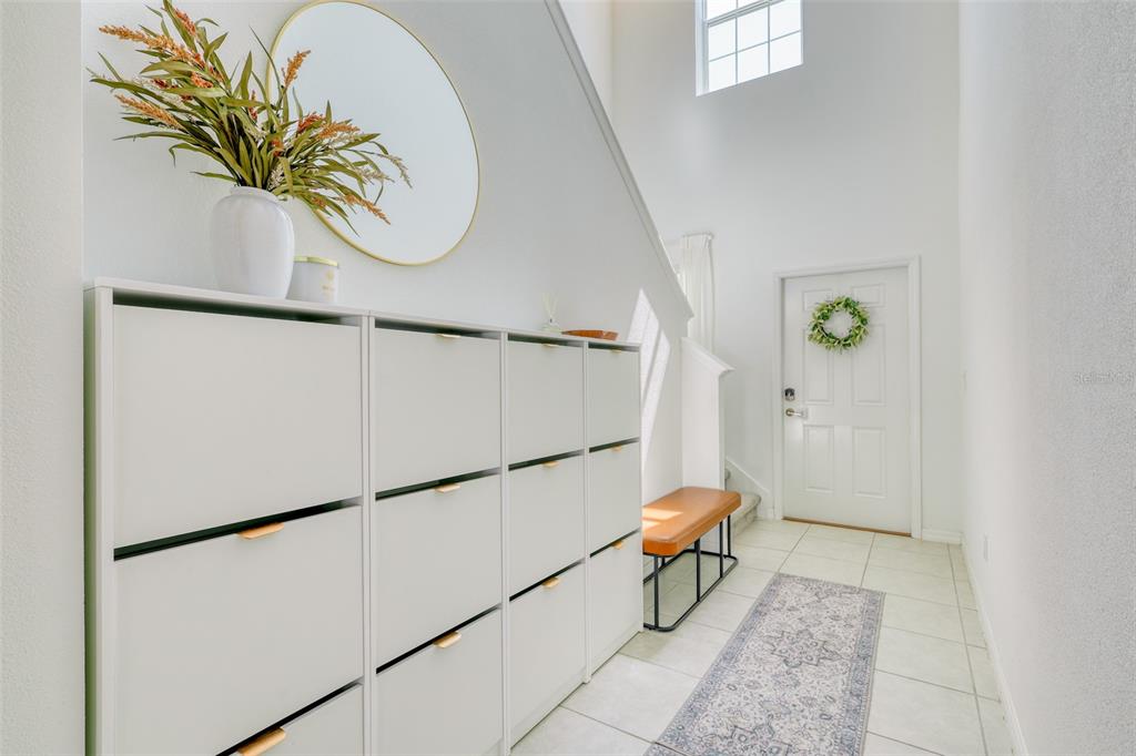 111 Rain Lily Ave Spring Hill Spring Hill, FL 34609 - Photo 36 of 60 a living room with a table and a potted plant