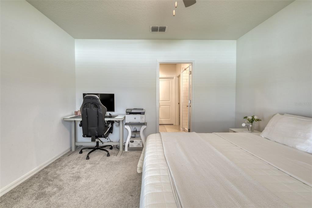 111 Rain Lily Ave Spring Hill Spring Hill, FL 34609 - Photo 38 of 60 a bedroom with a workspace