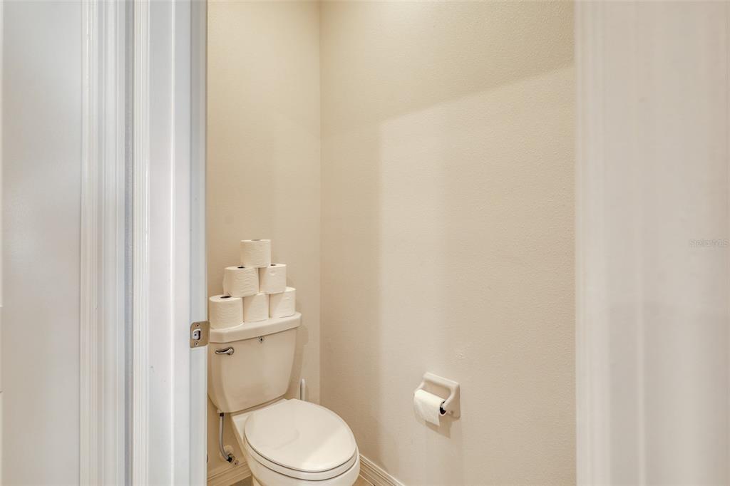 111 Rain Lily Ave Spring Hill Spring Hill, FL 34609 - Photo 40 of 60 a bathroom with a granite countertop toilet and a sink