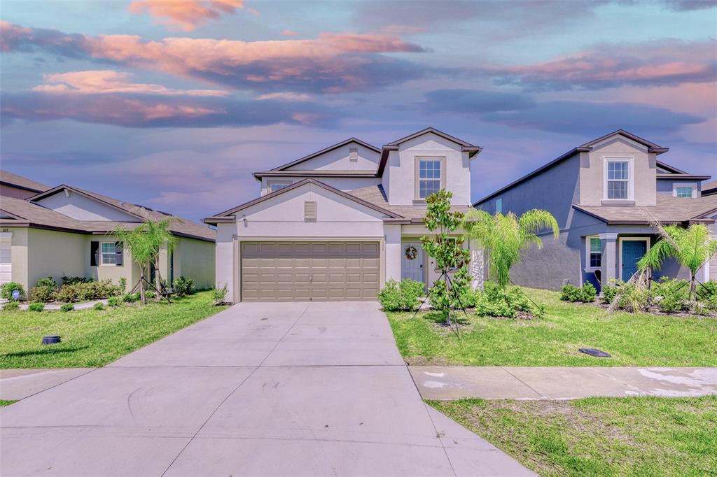 111 Rain Lily Ave Spring Hill Spring Hill, FL 34609 - Photo 48 of 60 a front view of a house with a garden