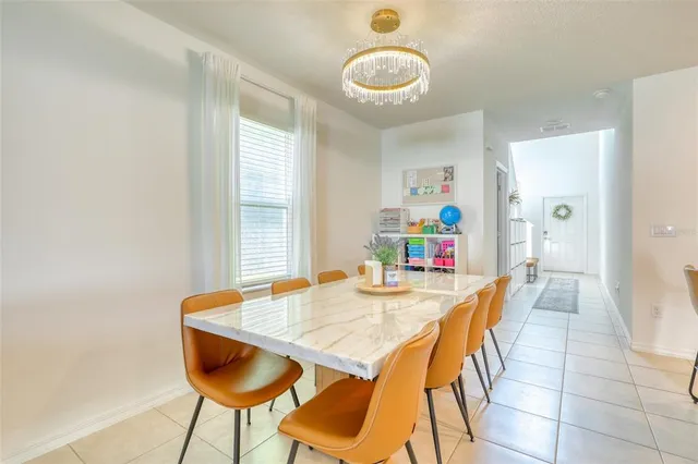 a view of a dining room with furniture and a chandelier