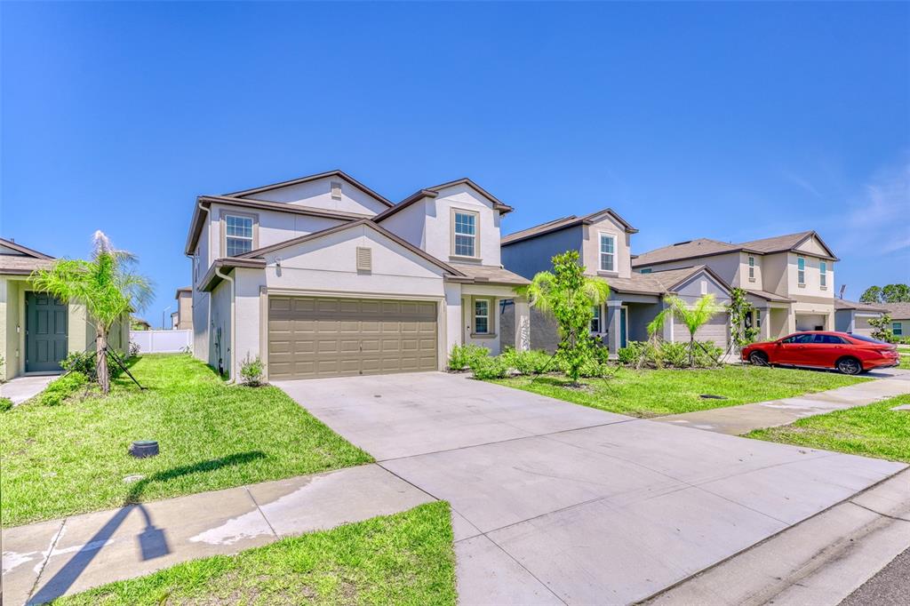 111 Rain Lily Ave Spring Hill Spring Hill, FL 34609 - Photo 10 of 60 a front view of a house with a yard and garage