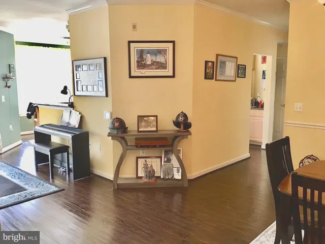 a view of a workspace with furniture and wooden floor