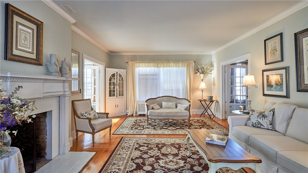 9 Elm Street Westerly, RI 02891 - Photo 6 of 37 Living room boasts fireplace and built-in corner cupboard.